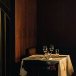 LASDUN Restaurant - a dark interior, with a table set for two.
