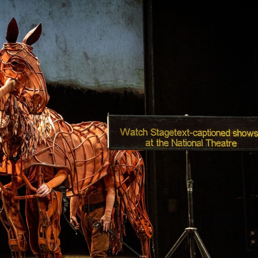 War Horse puppet and handlers and a Stagetext Caption screen with the message: Watch Stagetext-captioned shows at the National Theatre.